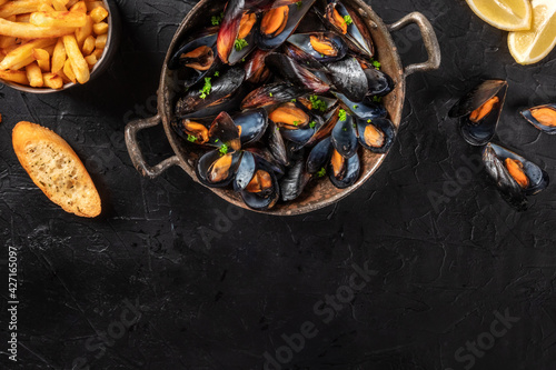 Mussels with a place for text, shot from above on a black background