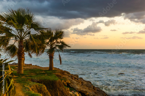 Cloudy sunset in the stormy sea on a tropical island.