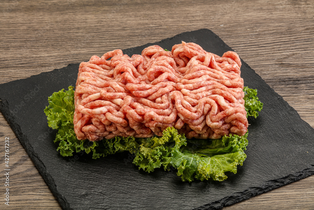 Raw pork minced meat over board Raw pork minced meat over board