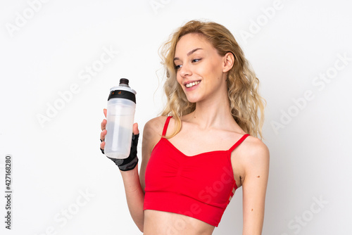 Young blonde woman isolated on white background with sports water bottle