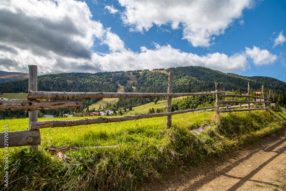 wooden fence on a background of a mountain village. Countryside.