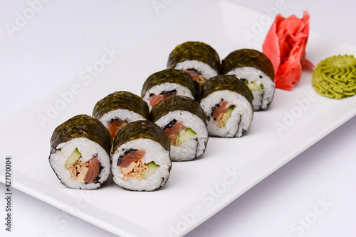 Japan sushi rolls isolated on white background served on a white plate.
