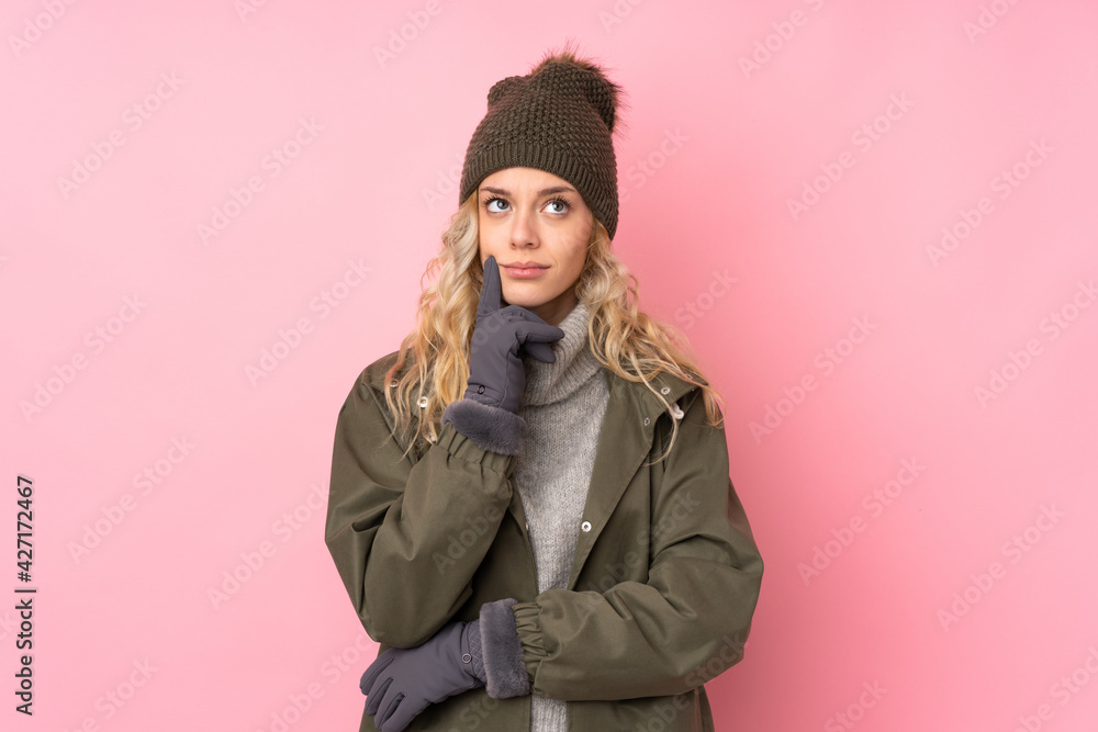 Young girl with winter hat isolated on pink background thinking an idea Young girl with winter hat isolated on pink background thinking an idea