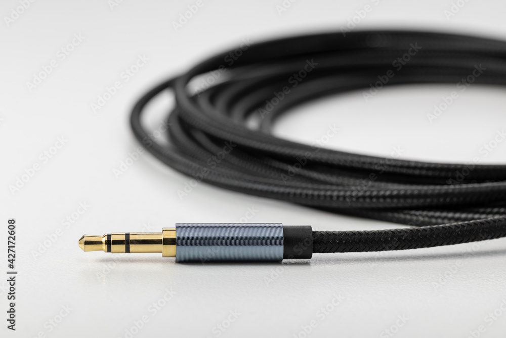 Black flexible audio cable with plug for connecting electronics. Black flexible audio cable with plug for connecting electronics.
