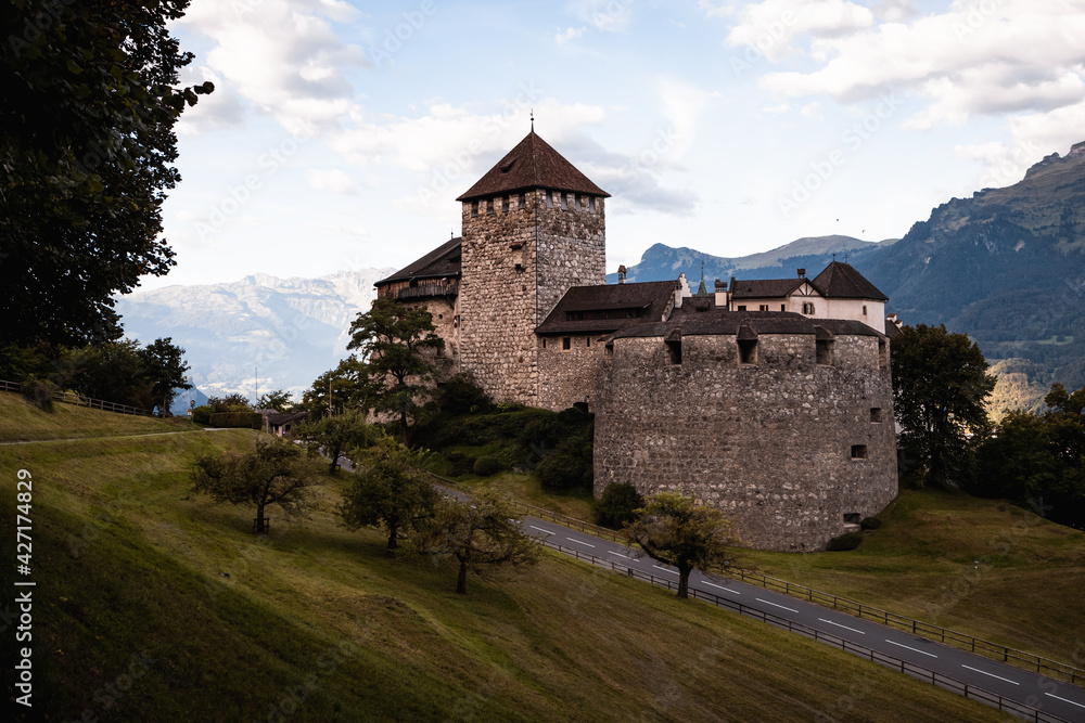 Sunrise at Castle Vaduz with curved road, blue sky and green forest (Vaduz, Principality of Liechtenstein, Europe) Sunrise at Castle Vaduz with curved road, blue sky and green forest (Vaduz, Principality of Liechtenstein, Europe)