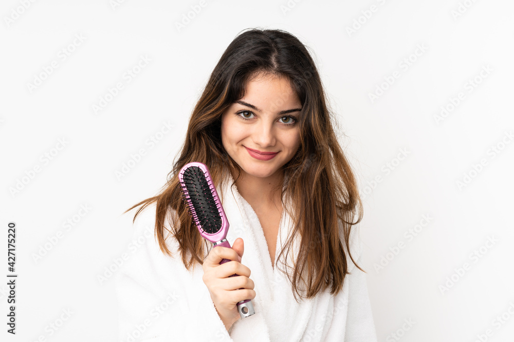 Young caucasian woman isolated on white background with hair comb Young caucasian woman isolated on white background with hair comb