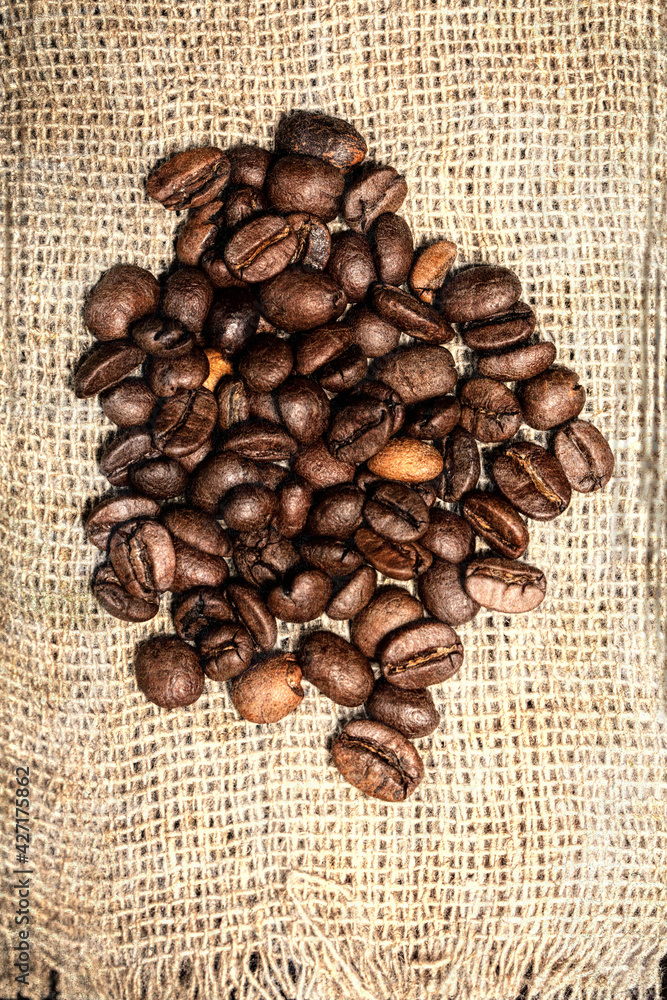 Coffee beans are scattered over the burlap. Coffee beans are scattered over the burlap.