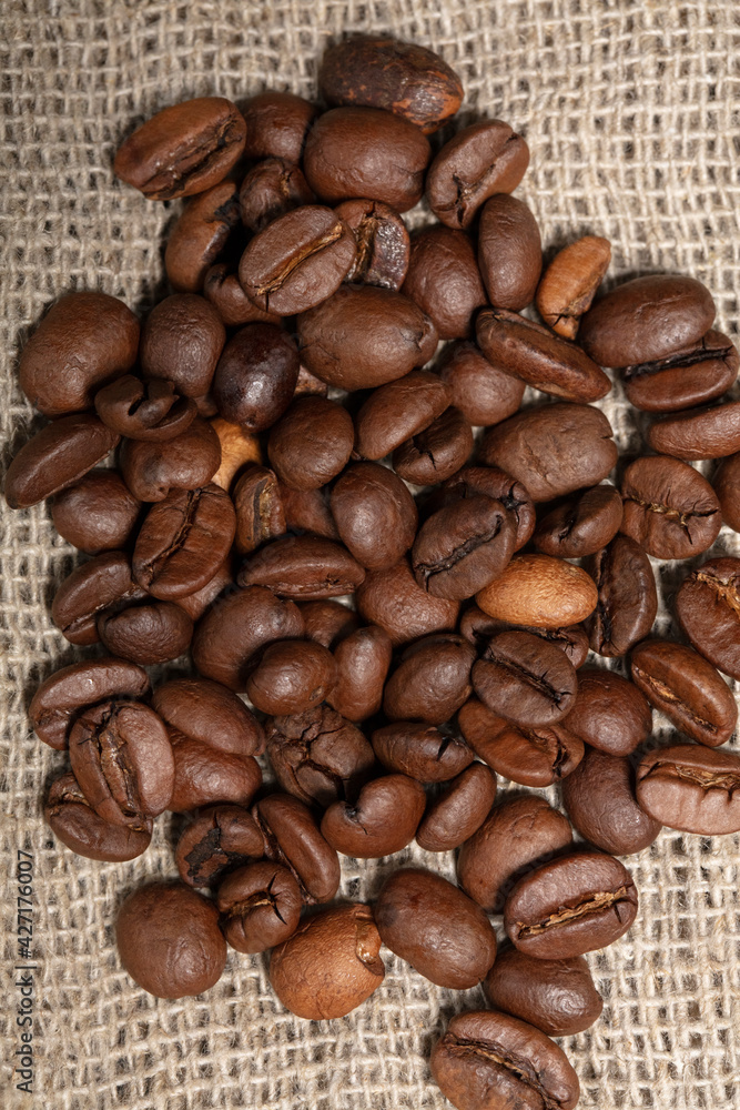 Coffee beans are scattered over the burlap. Coffee beans are scattered over the burlap.