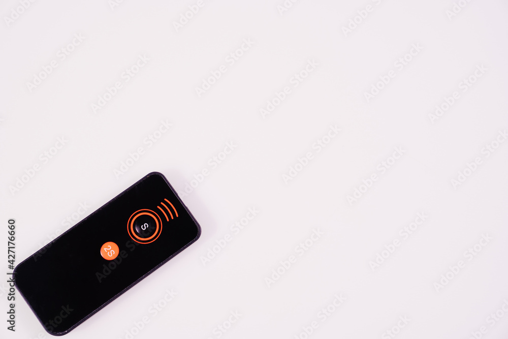 Black remote control for the camera on a white background. 