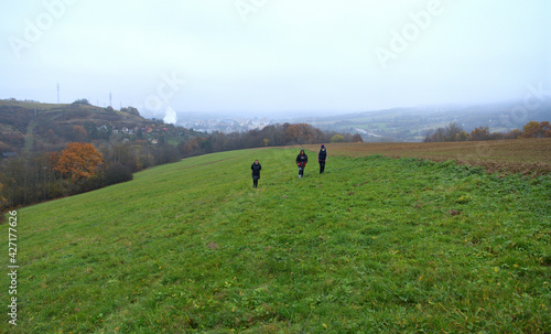 The family climbs up the hill together on a nature hike
