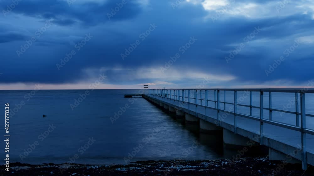 Storm clouds over ocean at sundown in time lapse Storm clouds over ocean at sundown in time lapse