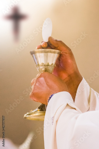 hands of the pope celebrated the Eucharist with body and blood of christ photo