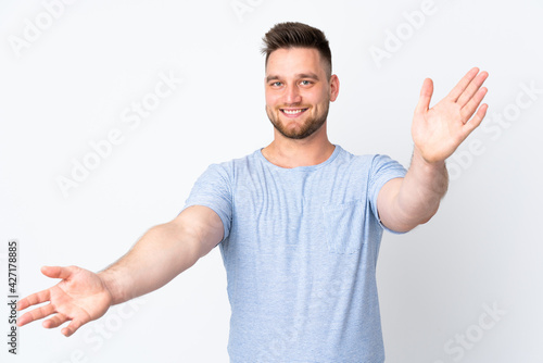 Russian handsome man over isolated background presenting and inviting to come with hand