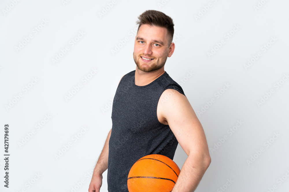 Russian handsome man isolated on white background playing basketball Russian handsome man isolated on white background playing basketball