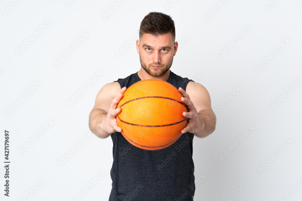 Russian handsome man isolated on white background playing basketball Russian handsome man isolated on white background playing basketball