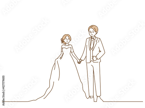 手をつないで目を合わせている新郎新婦
