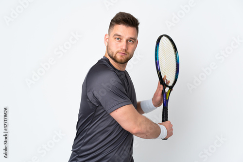 Russian handsome man isolated on white background playing tennis © luismolinero