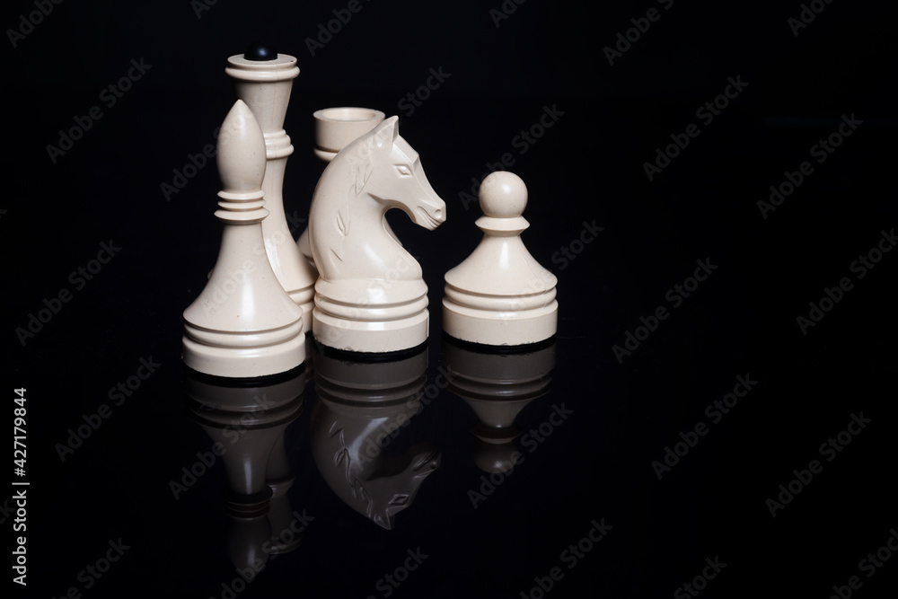 Chess set. White chess pieces isolated on black background. Chess set. White chess pieces isolated on black background.