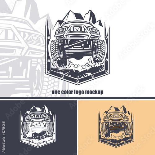 Logo of front view off-road car against a background of mountains in a shield. Monochrome layout.
