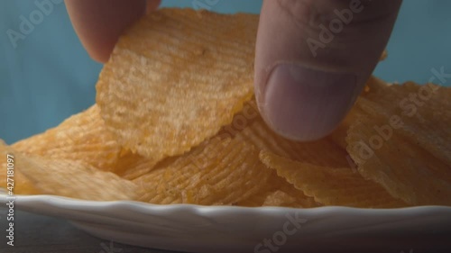 Man Grabs Handfuls Of Chips From Bowl
