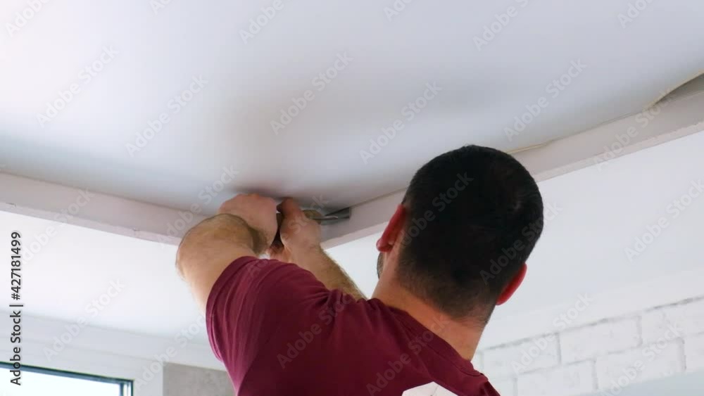 Workers stretch stretch ceiling in room. selective focus. Workers stretch stretch ceiling in room. selective focus.