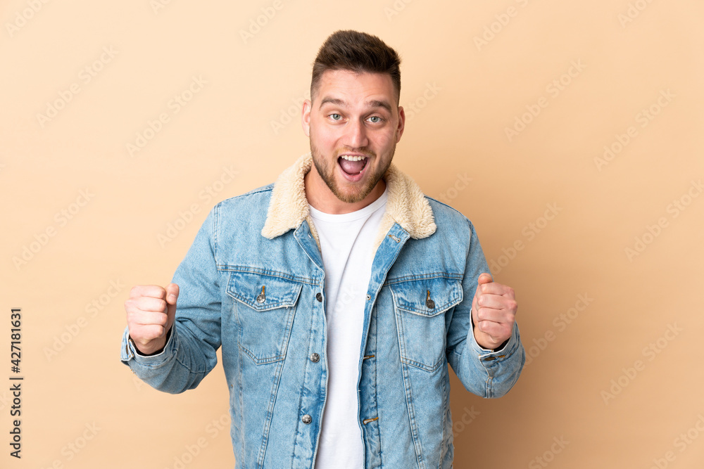 Russian handsome man over isolated background celebrating a victory in winner position Russian handsome man over isolated background celebrating a victory in winner position