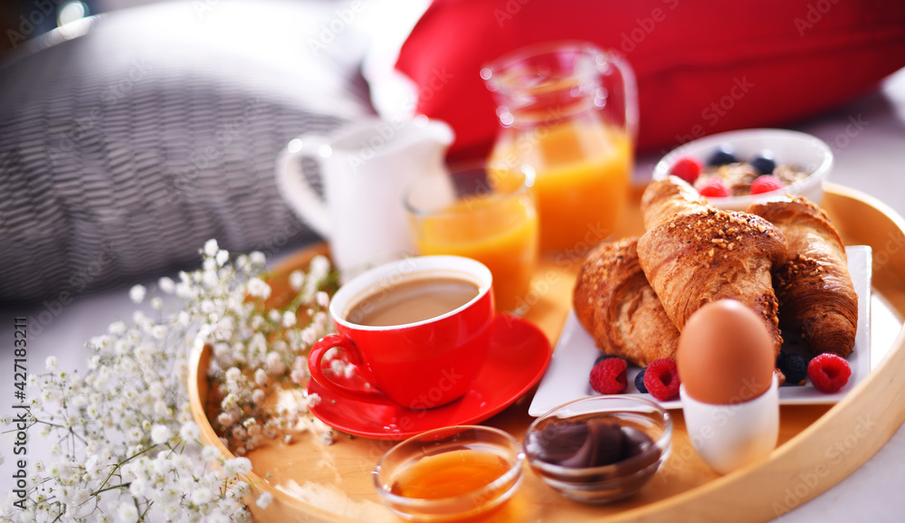 A tray with breakfast on a bed in a hotel room A tray with breakfast on a bed in a hotel room