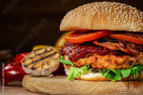 Close up of home made delicious burger on a wooden table.