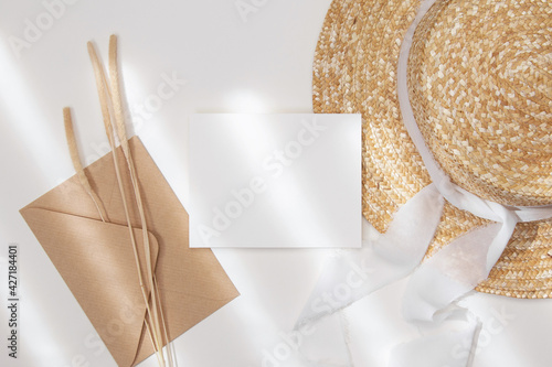 3,5x5 invitation card mockup with straw hat and envelope photo