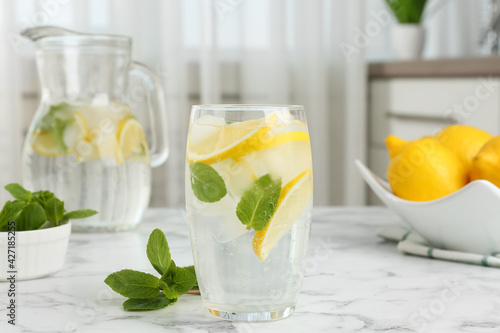 Delicious lemonade with mint on white marble table indoors