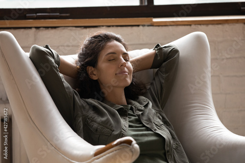 Obraz na plátně Close up mindful relaxed woman with closed eyes sitting in cozy armchair, stretc