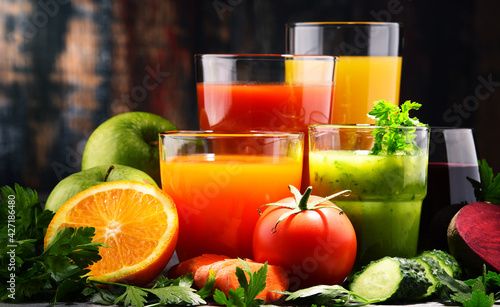 Glasses with fresh organic vegetable and fruit juices photo