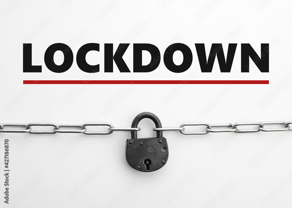 Concept of lockdown due to Coronavirus pandemic. Steel padlock and chain isolated on white, top view Concept of lockdown due to Coronavirus pandemic. Steel padlock and chain isolated on white, top view