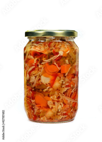 Glass jar with homemade pickled vegetable mix isolated on white background, top view.