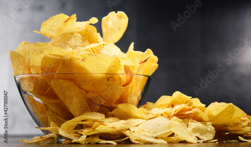 Canvas Print Composition with bowl of potato chips on wooden table