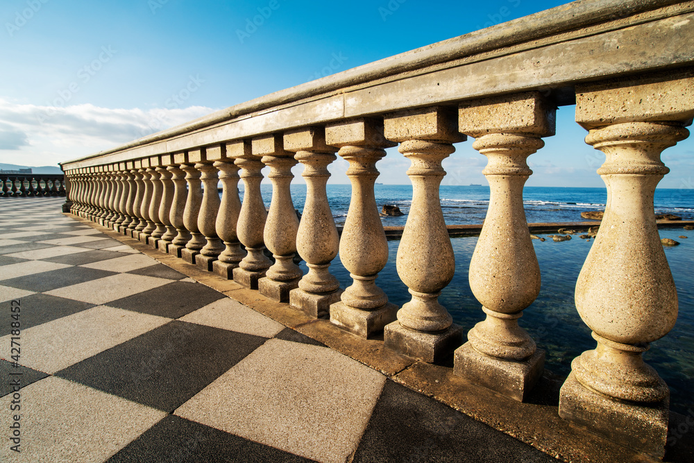 Fototapeta premium The columns of the balustrade overlooking the sea of the Terrazza Mascagni Livorno