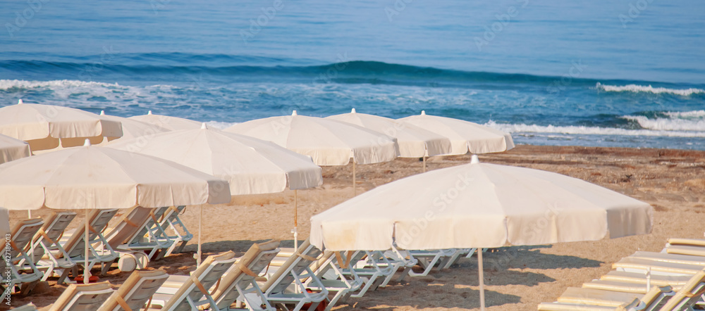 Coronavirus, covid-19, quarantine and epidemic concept. Empty beach with beach umbrellas, nobody on the beach.