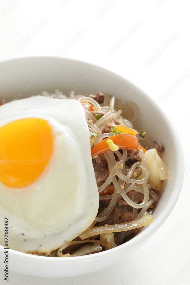 sunny side up fried egg on Korean Japchea green noodles stir fried sunny side up fried egg on Korean Japchea green noodles stir fried