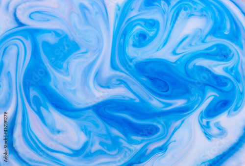 Abstract background of swirling blue waves of ink