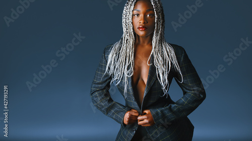 a fashionable african woman with dreads in a jacket
