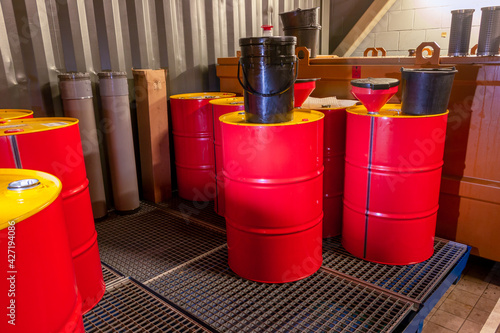 Industrial storage of oil barrels in a factory space, specially equipped for chemical waste, the Netherlands photo