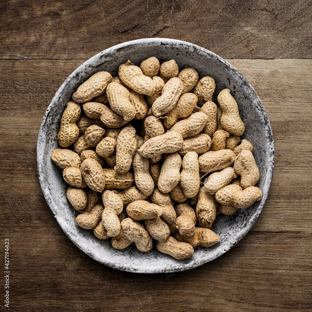 Peanuts flat lay on wooden table Peanuts flat lay on wooden table