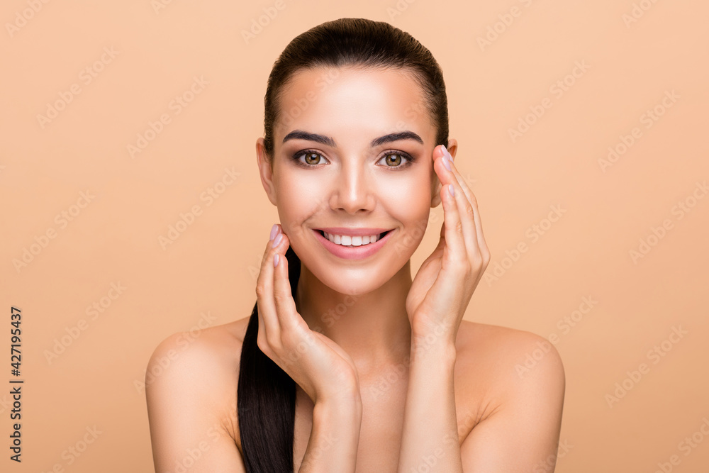 Photo of optimistic brunette hairdo lady hands face without clothes isolated on pastel beige color background