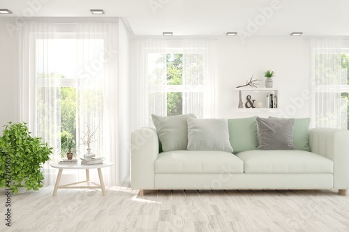 White living room with sofa and summer landscape in window. Scandinavian interior design. 3D illustration © AntonSh