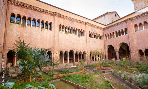 The European garden inside the cloister of the Basilica of San Lorenzo,with long corridor built in the 12th century,The environment is relaxing , peaceful and pleasant to live. photo