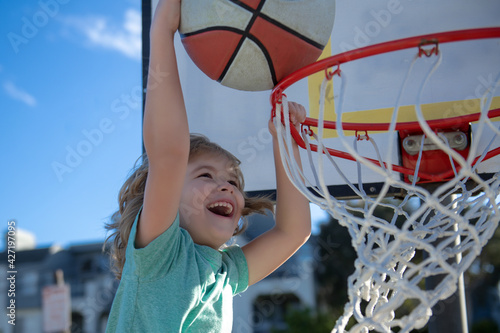 Kids playing basketball. Child sport activity. Funny excited child sportsman.