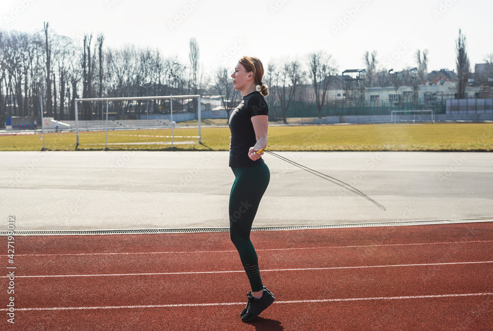 Fototapeta premium Woman jumping rope in the stadium.