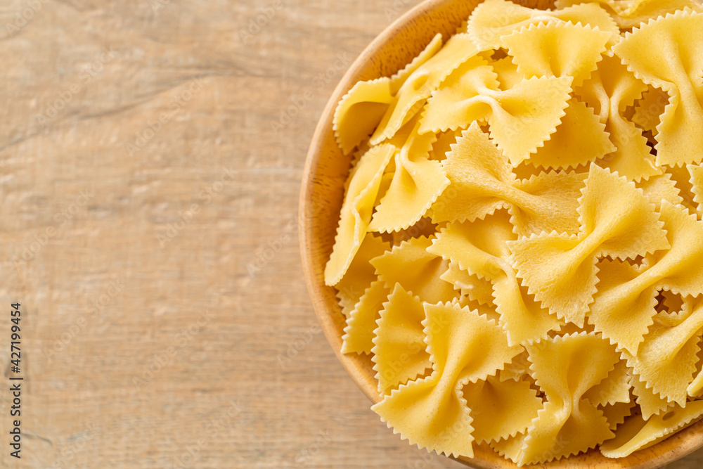Dry uncooked farfalle pasta in bowl Dry uncooked farfalle pasta in bowl