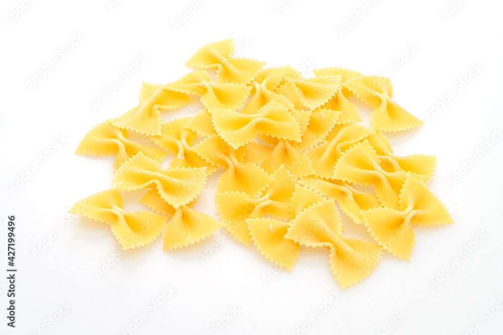 Dry uncooked farfalle pasta on white background Dry uncooked farfalle pasta on white background