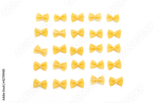 Dry uncooked farfalle pasta on white background photo